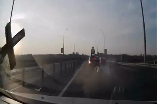 Tay lái xe máy ‘làm xiếc’ trên nóc ôtô